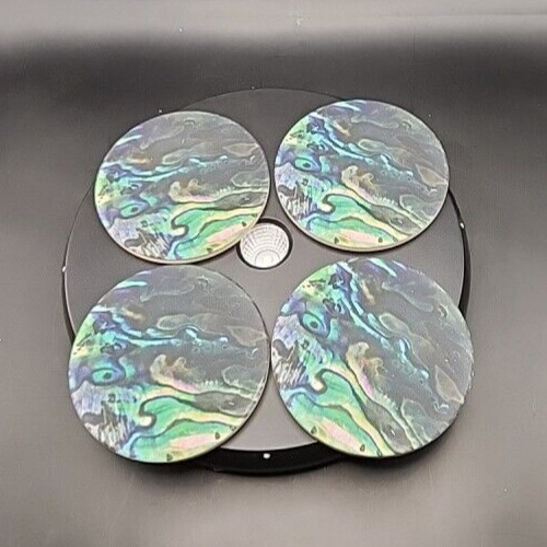 Set of four abalone-colored ceramic coasters with cork backing for drinks.