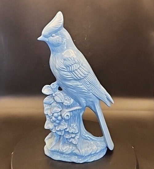Ceramic glazed blue jay bird statue on stump with flowers, signed, 10/75 inches.