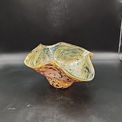 Colorful blown glass art with white, orange, and yellow molten design.