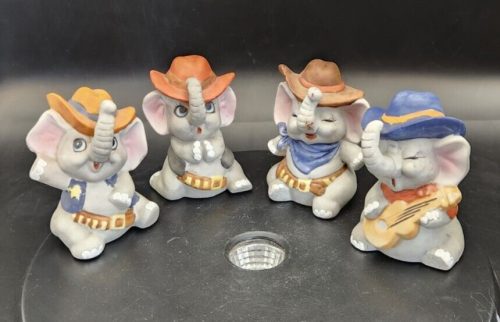 Set of four Enesco cowboy sheriff elephant figurines for Western decor and collectibles.