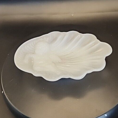 Vintage Avon milk glass cherub soap dish with decorative design.