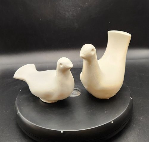 Two white ceramic decorative birds for homecoming and festive decor.