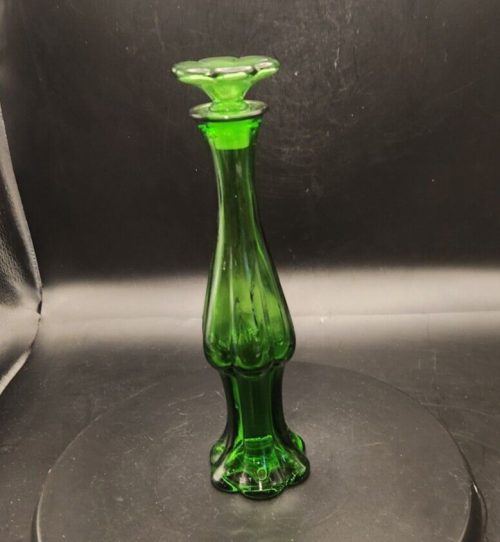 Avon green glass bud vase with stopper and empty cologne bottle, 9 inches tall.