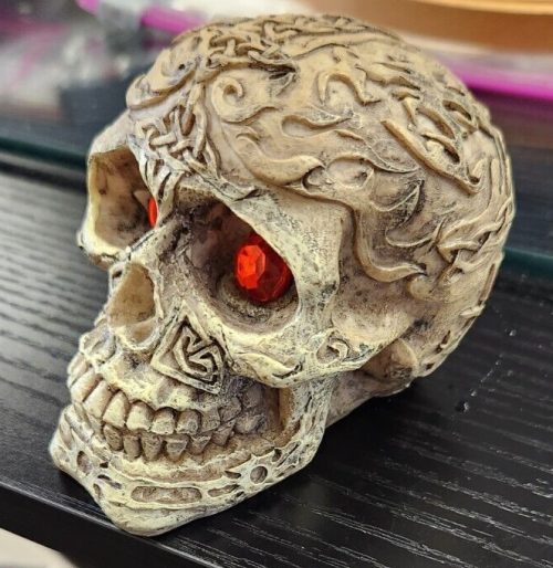 Celtic and flames design 4.5-inch resin skull sculpture.