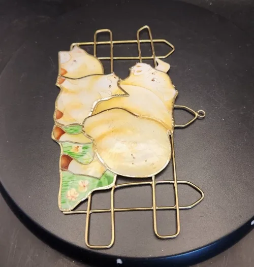 Colorful stained glass pig sun catcher for window decoration.