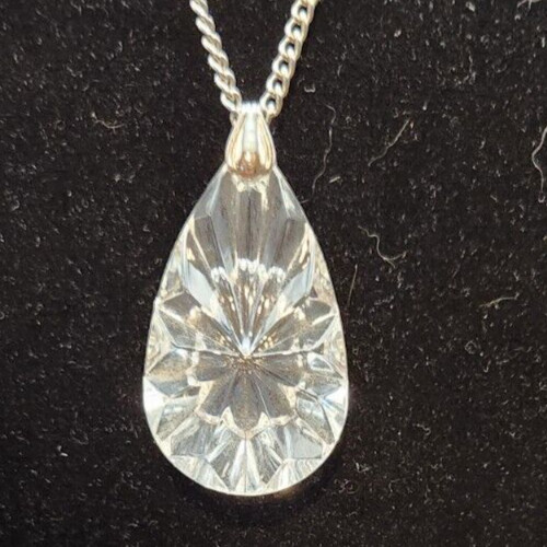 Elegant crystal drop pendant necklace on a long chain.