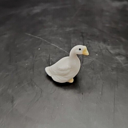 Mini ceramic duck house with bug shelter for decorative garden decor.