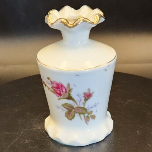 Porcelain bud vase with gold accents for elegant floral decor.