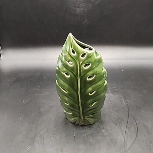 Beautiful green glazed ceramic vase with leaf design for decorative floral arrangements.