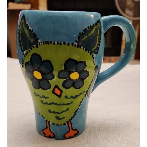 Handmade blue ceramic owl mug with signature, perfect for coffee or tea.