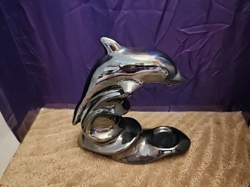 Black iridescent dolphin candle holder for tea lights, ceramic nautical decor.