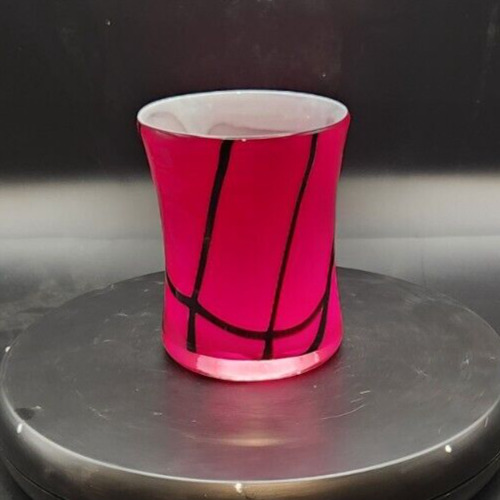 Hand-blown red and black swirl glass vase for decorative display.