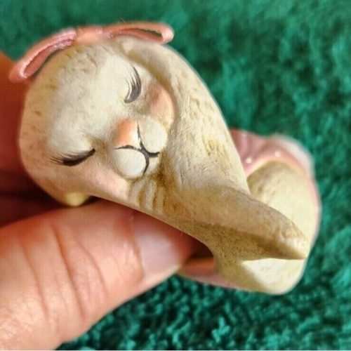 Cute sleeping baby girl bunny figurine in pink diaper, perfect for nursery decor.