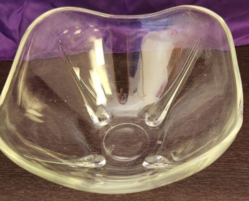 Elegant square glass footed bowl for decorative and functional tabletop display.