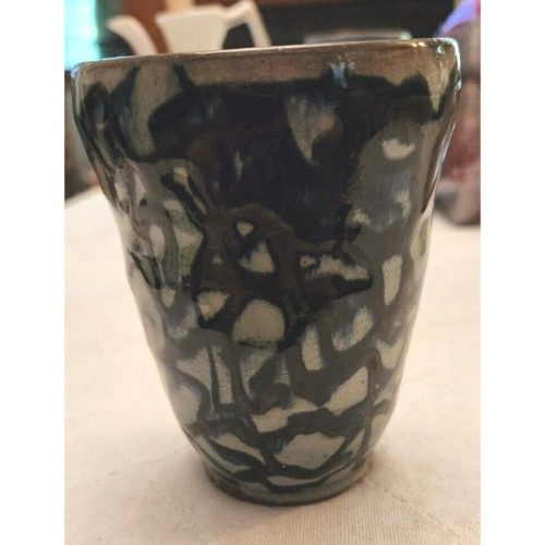 Handcrafted stoneware drip-glazed drinking vessel with unique glaze pattern.