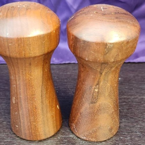 Teak wood salt and pepper shaker set for kitchen seasoning.