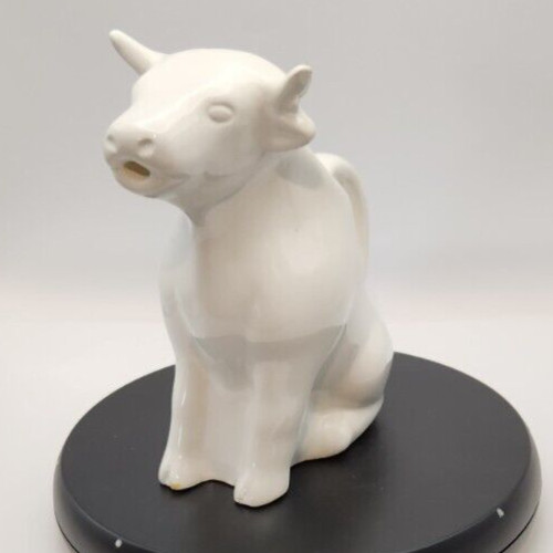 White ceramic cow pitcher for farmhouse decor and kitchen use.