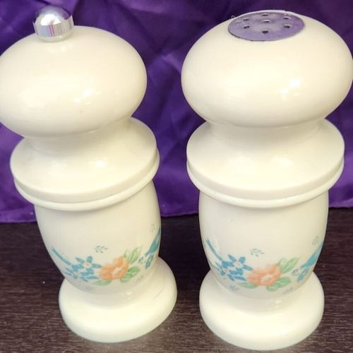 White floral salt and pepper grinder set for stylish kitchen use.