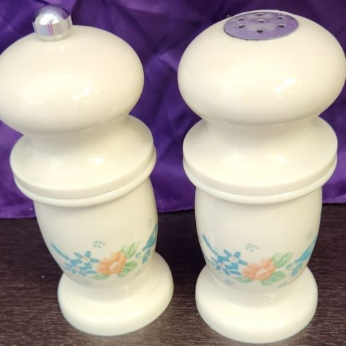 White floral salt and pepper grinder for kitchen seasoning.