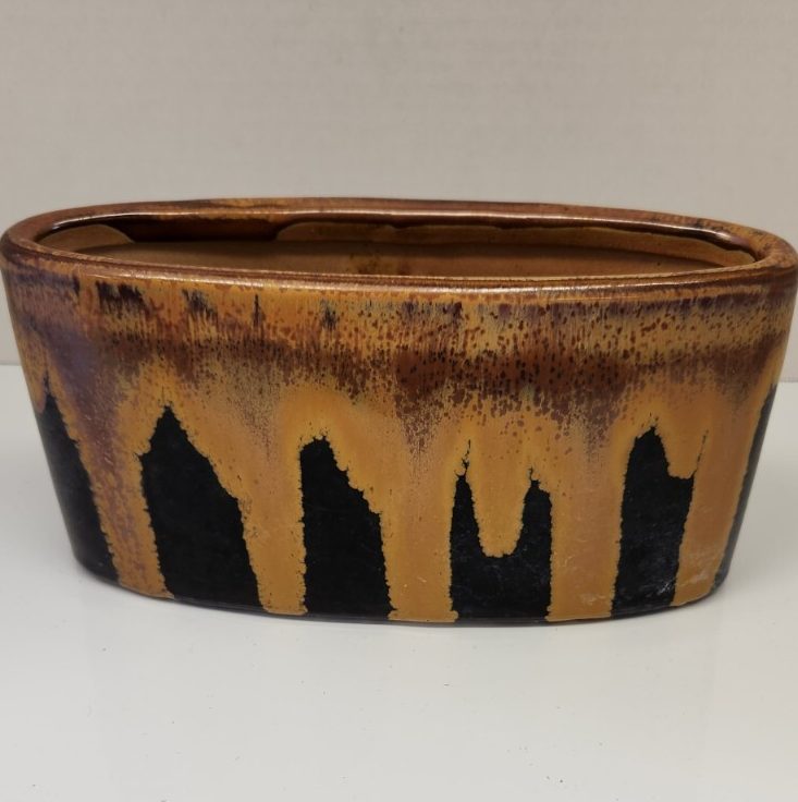 Brown and black drip glazed spring planter with numbered design.