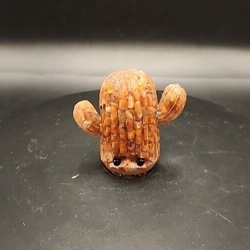 Cute acrylic pebbles cactus with eyes figurine for decorative or collectible purposes.
