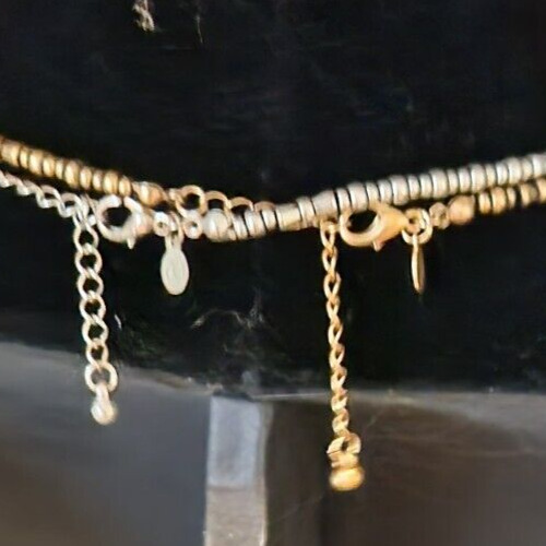 Elegant two-tone square pendant necklace with geometric design and shiny finish.