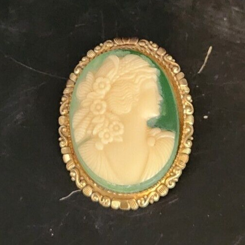 Vintage Victorian gold-toned cameo brooch, oval celluloid jewelry, antique collectible accessory.