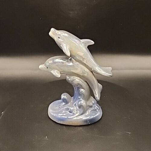 White iridescent dolphin figurine with glossy glaze.